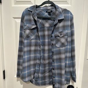 Blue and grey flannel. It is thin but also oversized. Great for the fall!